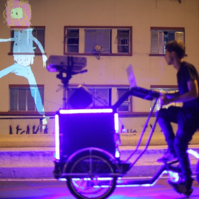 VoxMagna Agency, Projecting tricycle, projecting bikes, roving artists, mobile animations, city tours, events, Mariana Rinaldi, Animations on bikes, tagtool, projector on bike, new media artists, artists, marketing, digital art, digital artists
